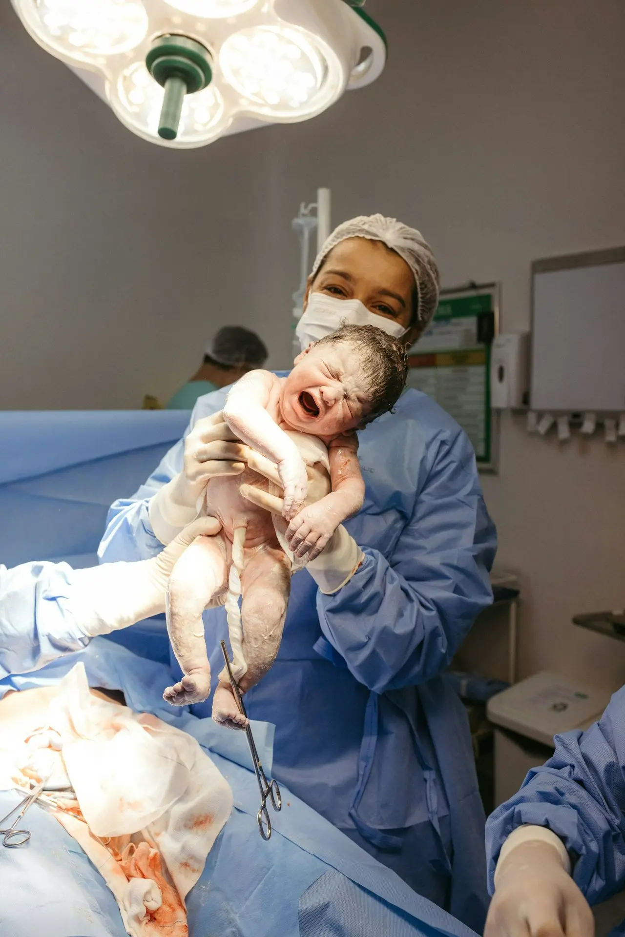 a man holding a baby in a hospital room